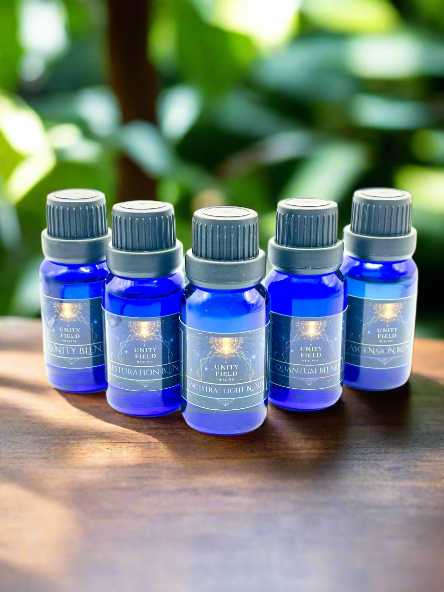 Set of five blue essential oil bottles with gray caps on a white background