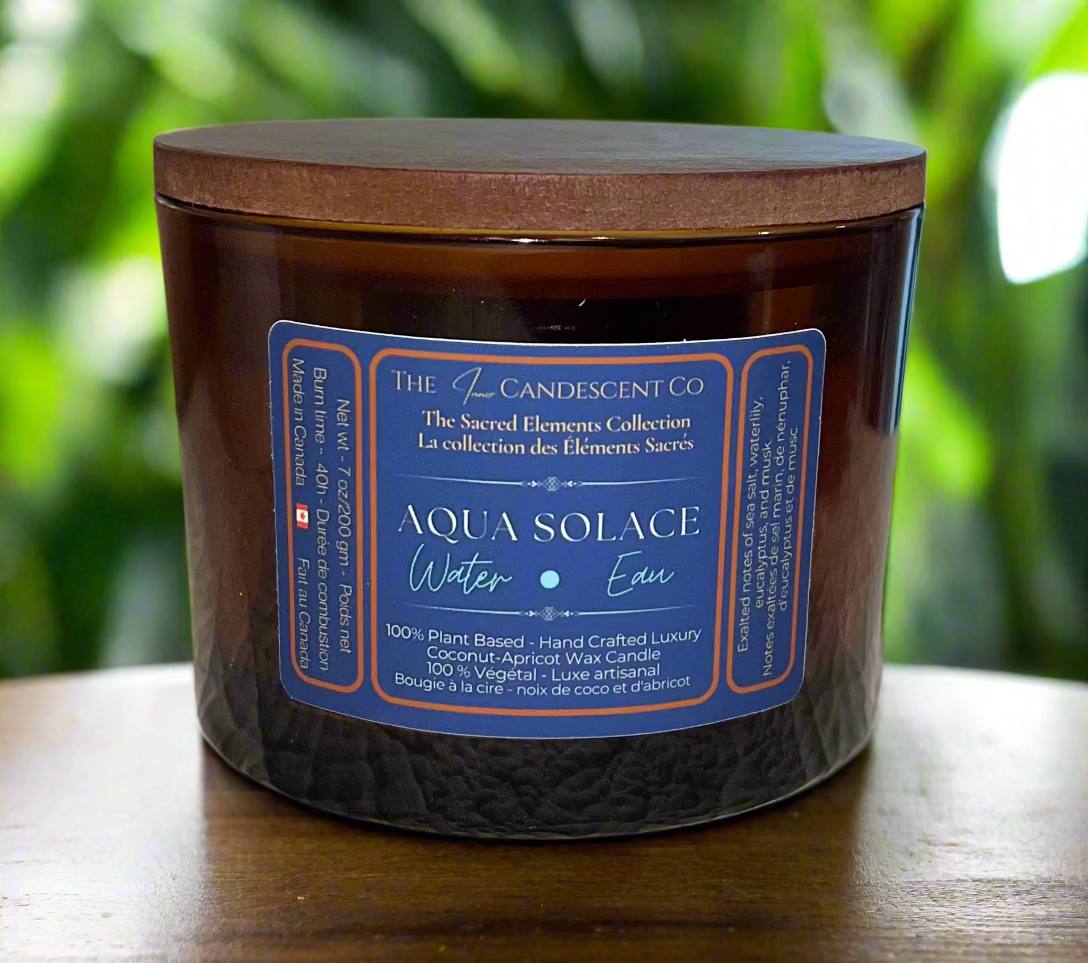 Candle with a wooden lid and blue label on a textured surface