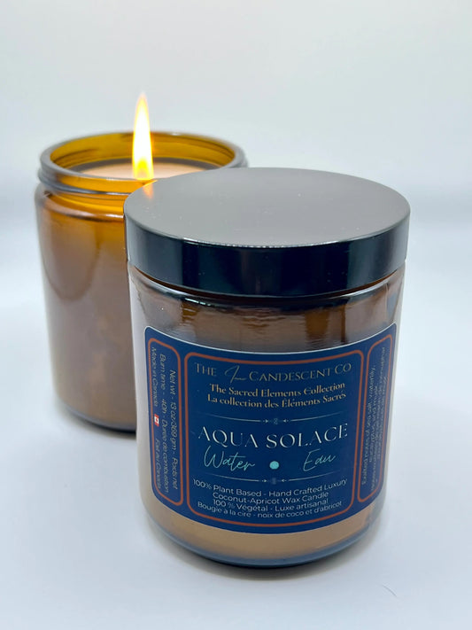 Candle jar with blue label and silver lid on a white background