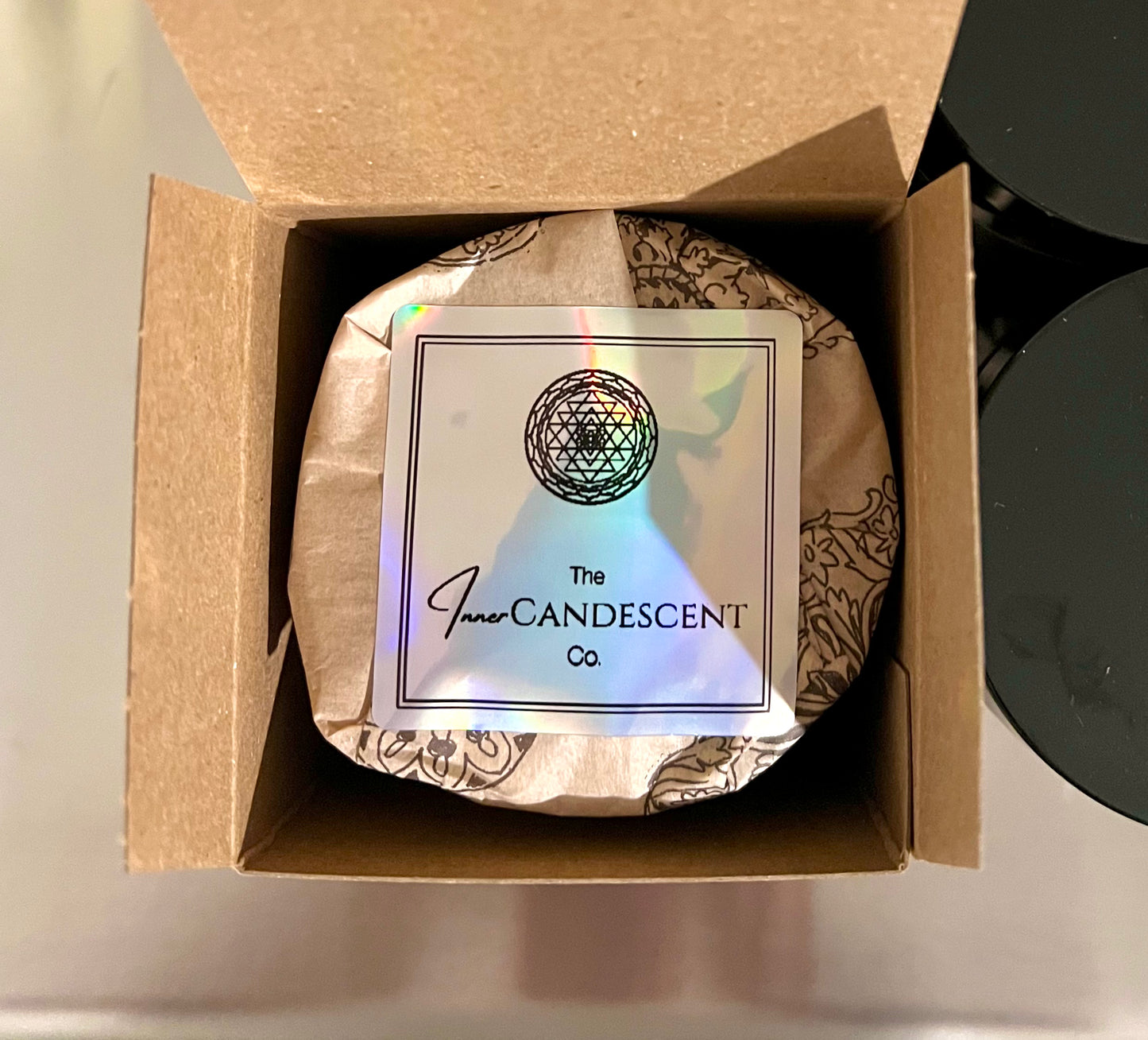 Candle in a box with 'The Inner Candescent Co' label