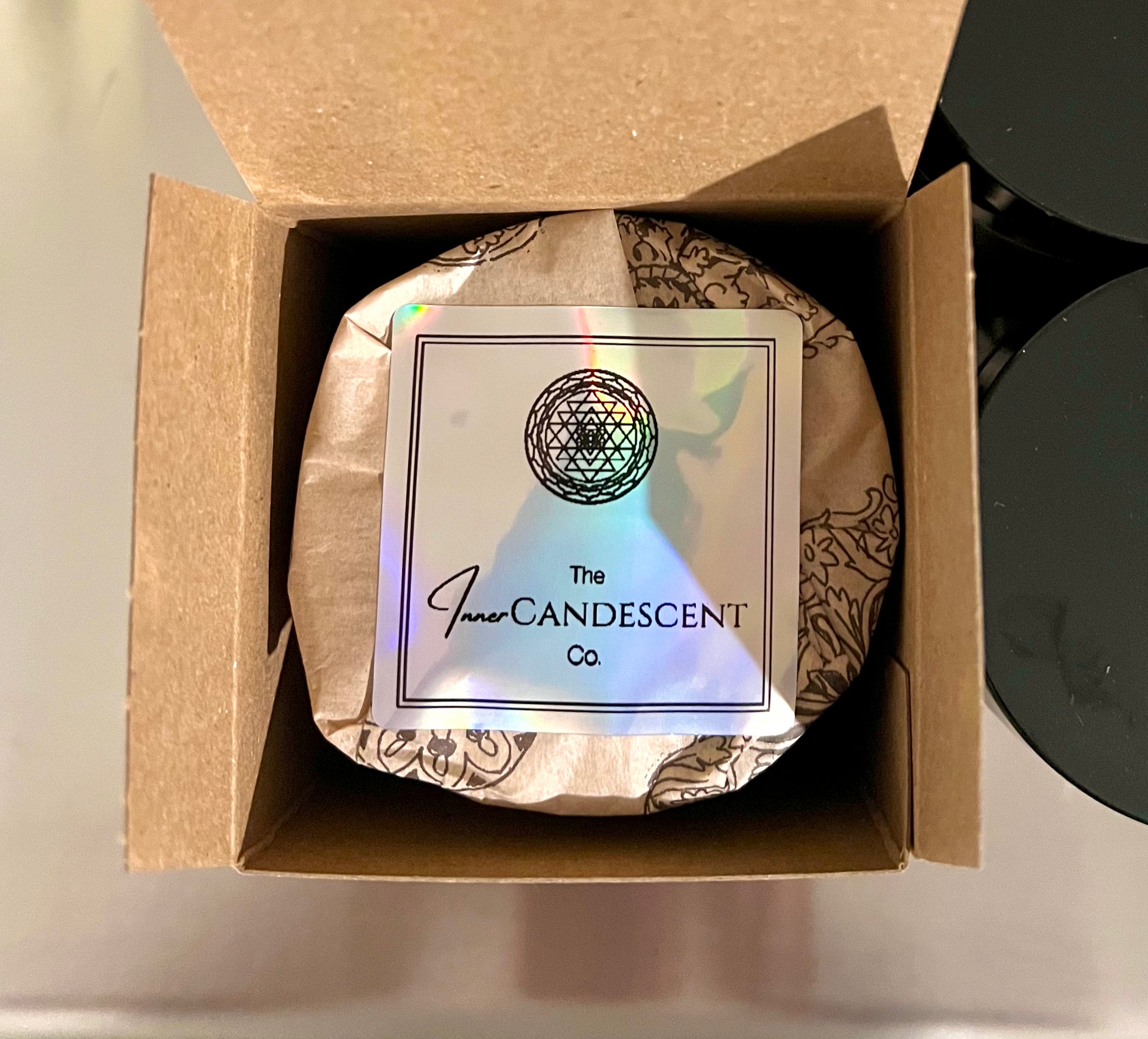 Candle in a box with 'The Inner Candescent Co' label