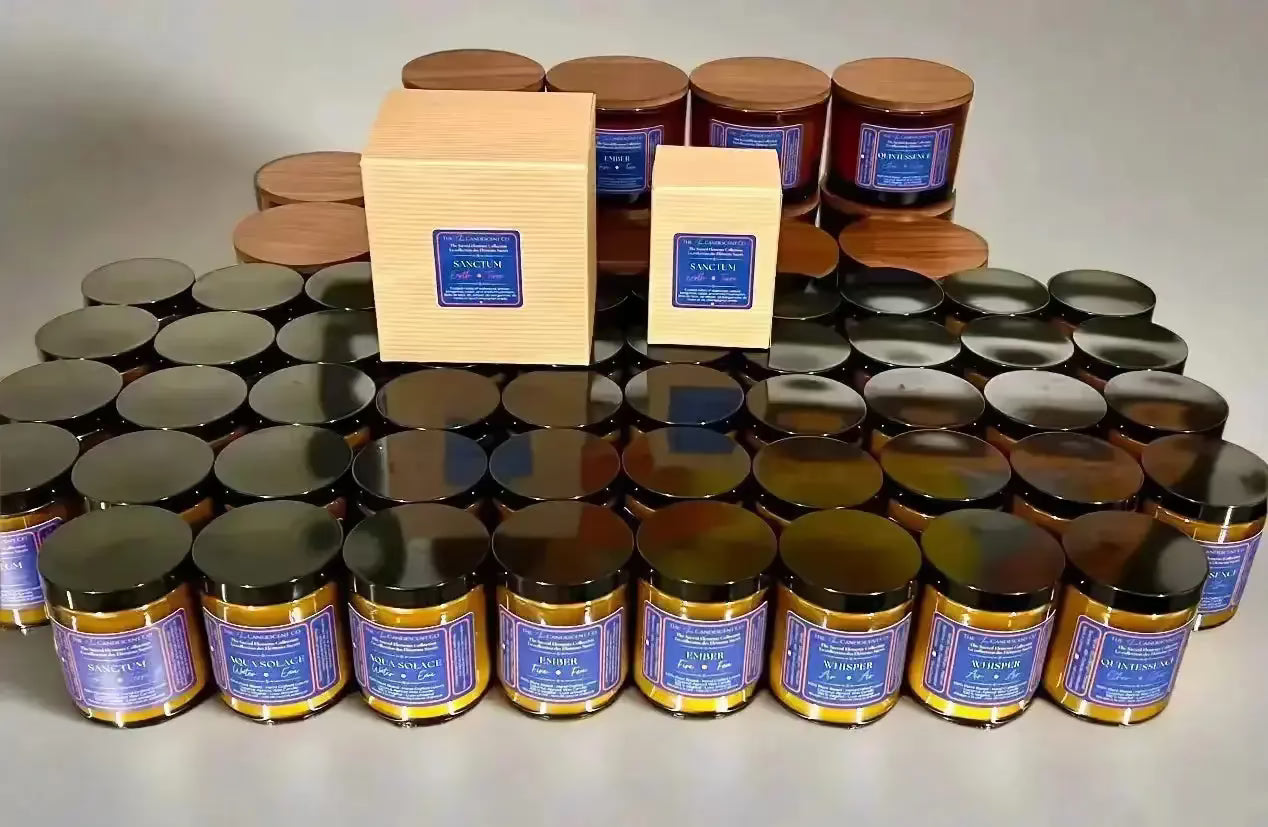 Collection of jars with blue labels and wooden boxes on a reflective surface.