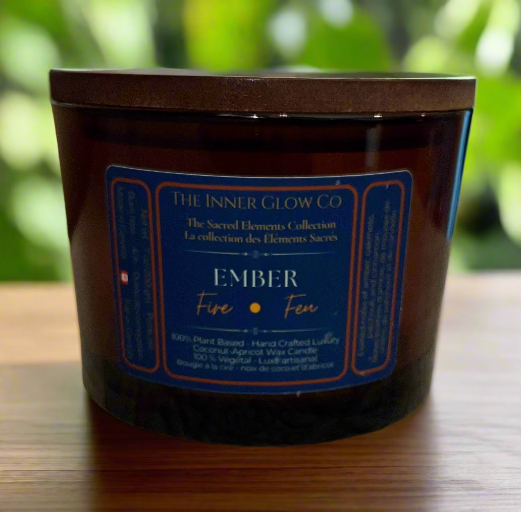 Brown candle jar with blue label on a textured surface