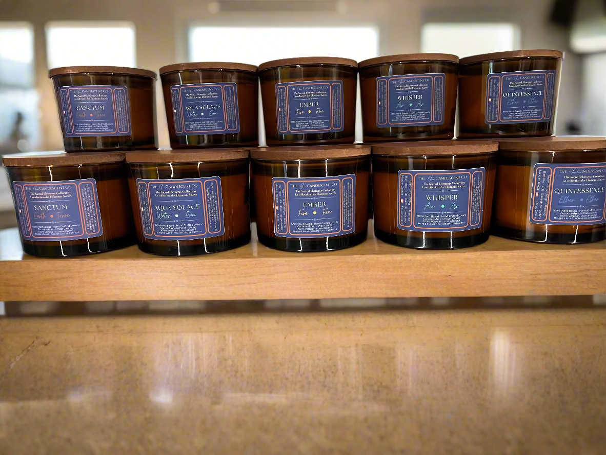 Row of candles with labels on a reflective surface