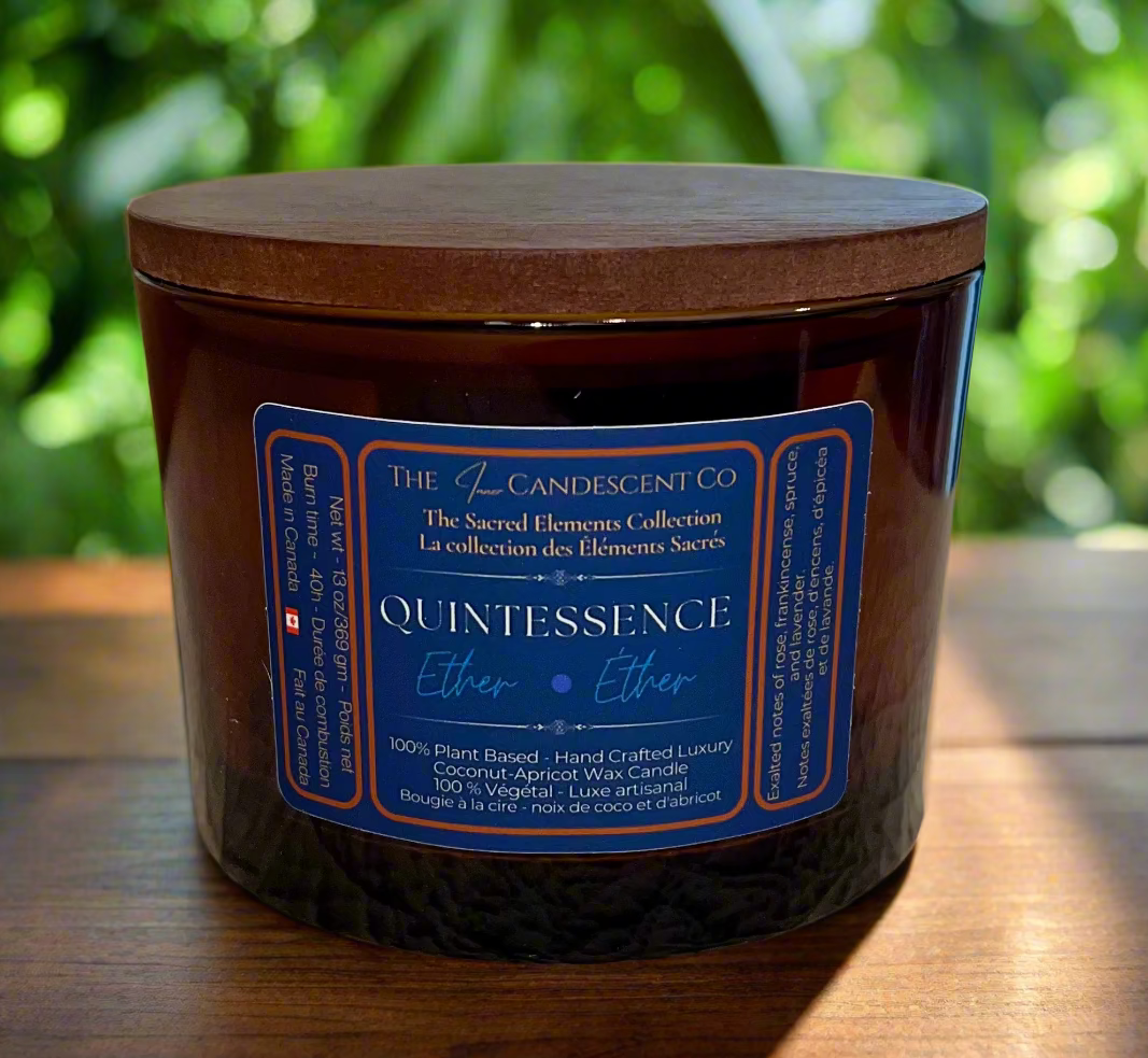 Candle jar with a wooden lid and blue label on a textured surface