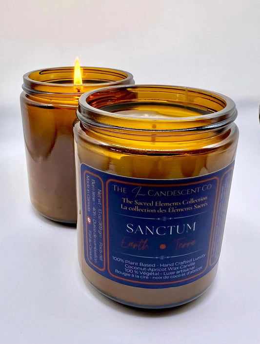 Candle in an amber glass jar with a blue label on a white background