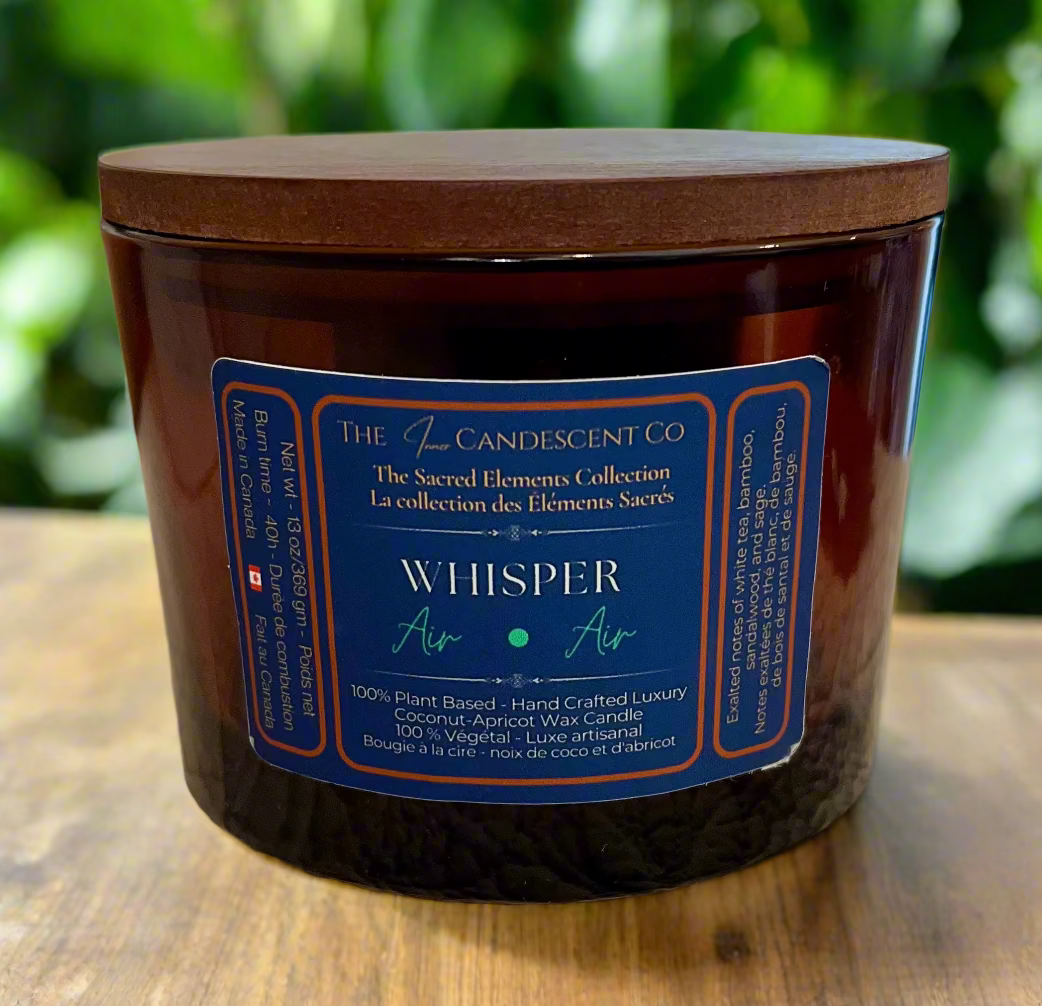 Candle jar with a wooden lid and blue label on a textured surface