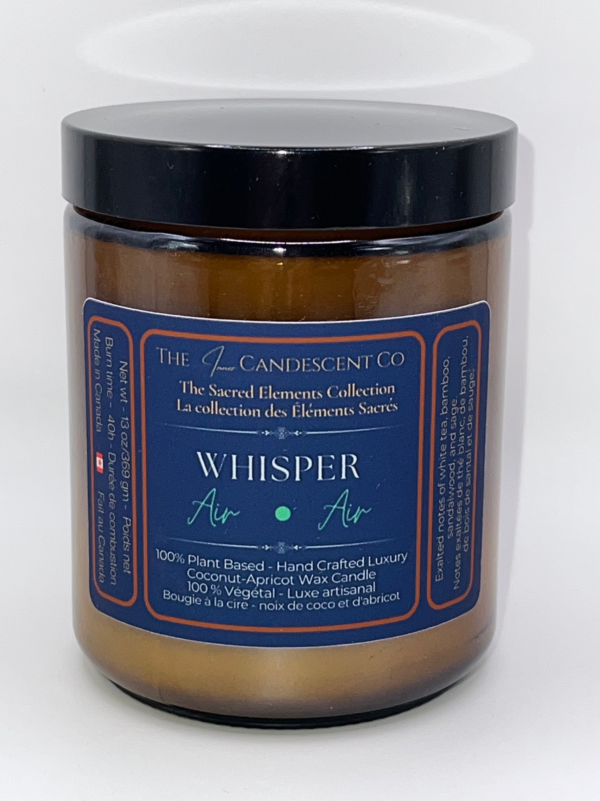 Candle jar labeled 'Whisper' from The L'Candescent Co on a white background