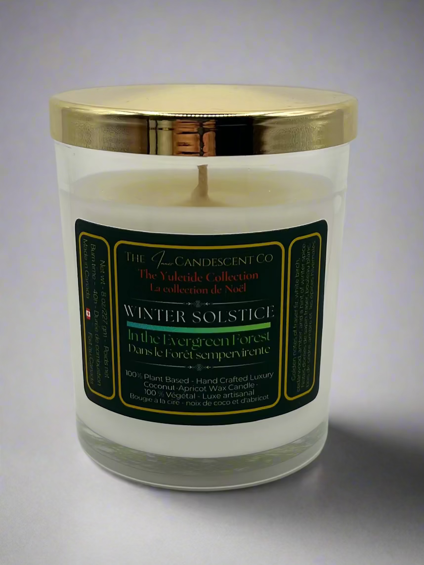 Candle with a gold lid and green label on a white background