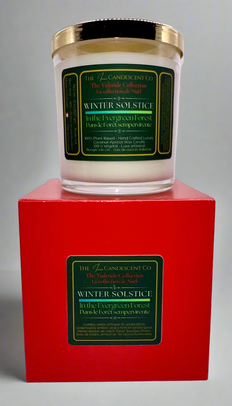 Candle with green label on a red box against a white background