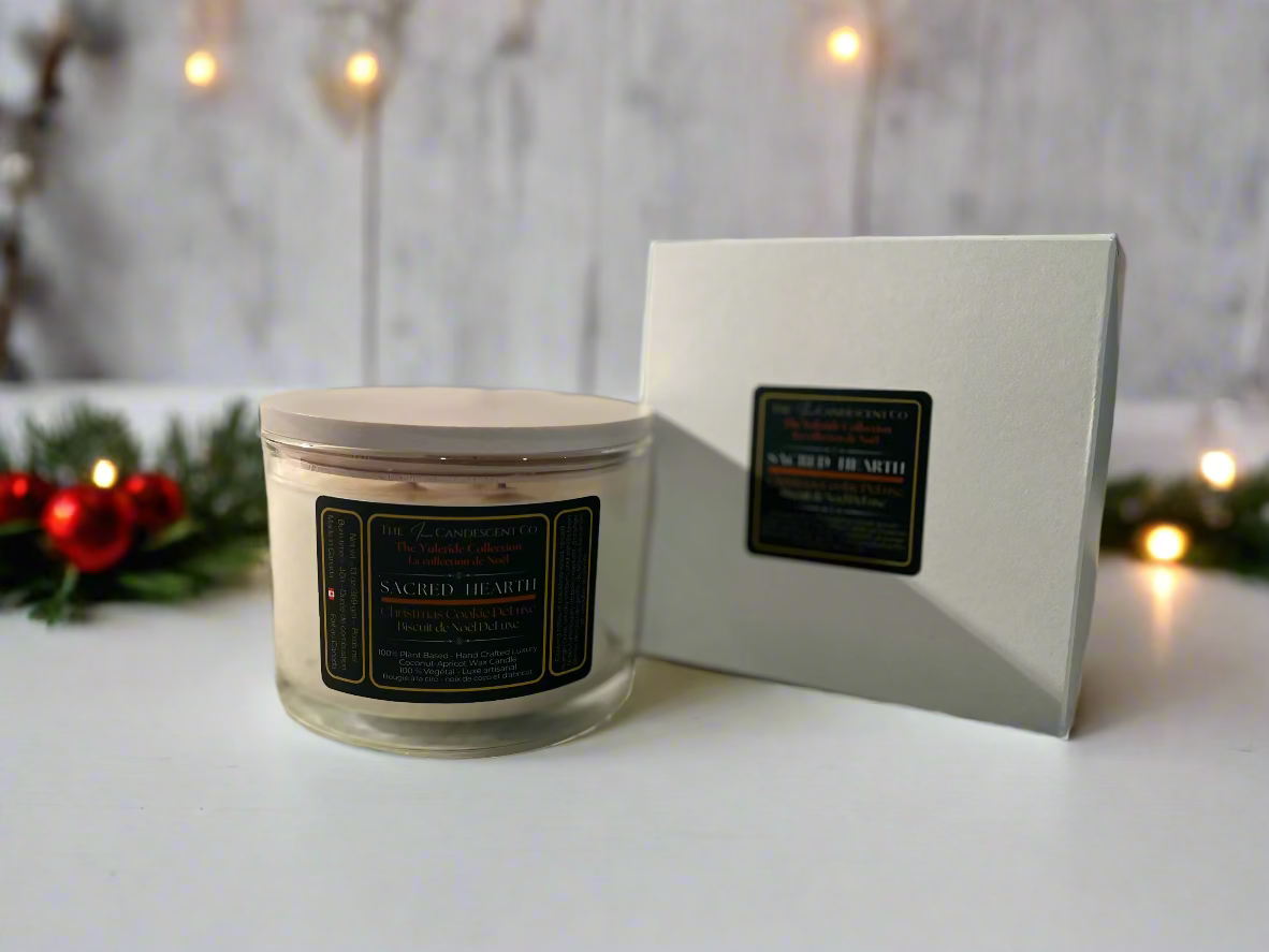 Candle with a white lid and black label on a textured surface, with a matching box in the background.