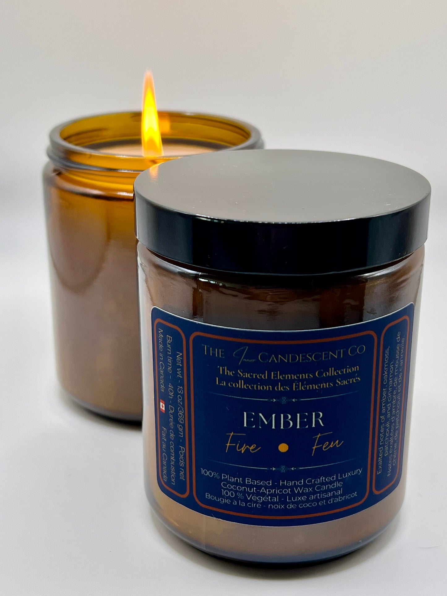 Candle in a glass jar with a black lid, featuring a label on a white background