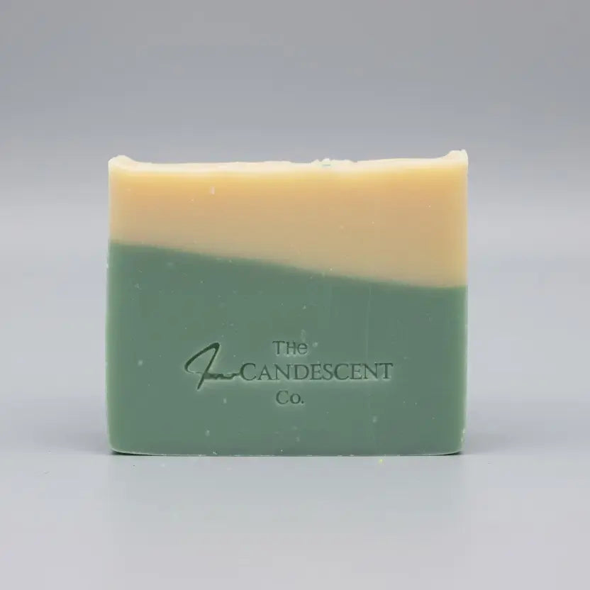 Two bars of soap with a visible brand logo on a textured surface.