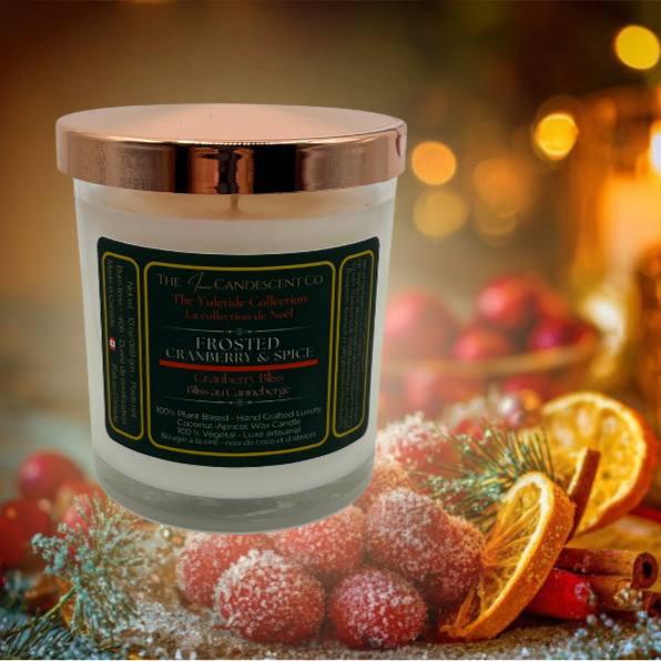 Frosted Cranberry & Spice candle with decorative fruits and spices on a blurred festive background