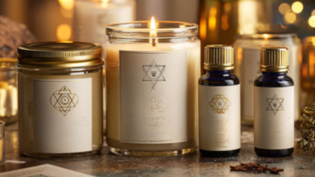 Candle and essential oil bottles with a blurred background