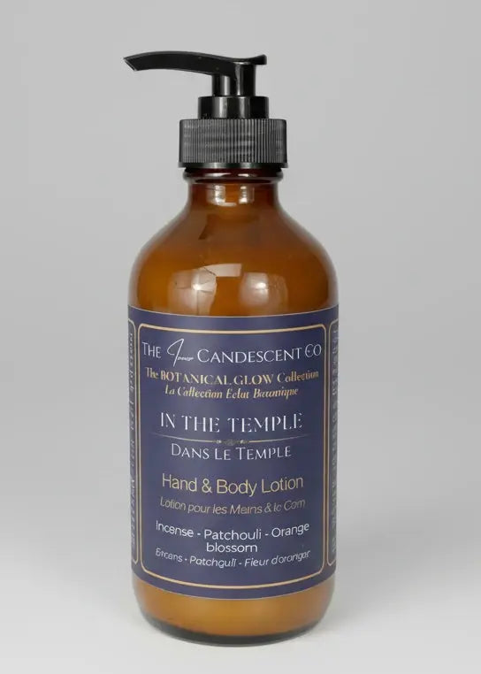 Bottle of 'In the Temple' hand and body lotion with incense burning in the background