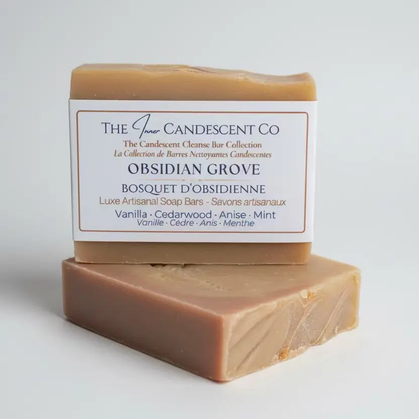 Two soap bars with a box labelled 'The Inner Candescent Co' on a textured surface.