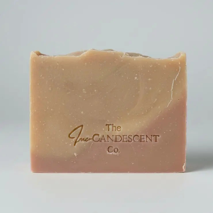 Bar of soap with 'The Candescents Co.' branding on a textured surface.