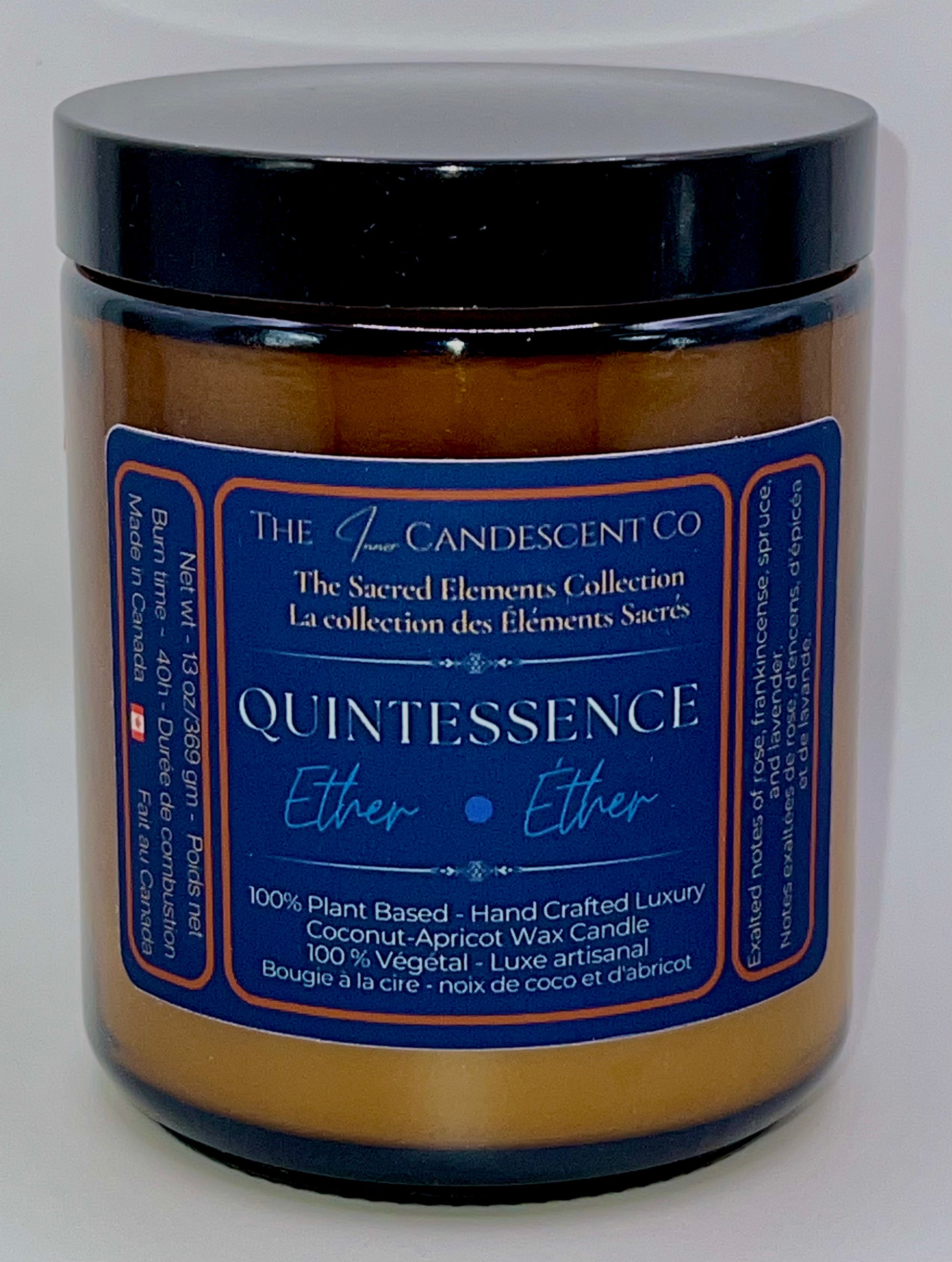Candle jar labeled 'Quintessence' from The Candescent Co on a white background