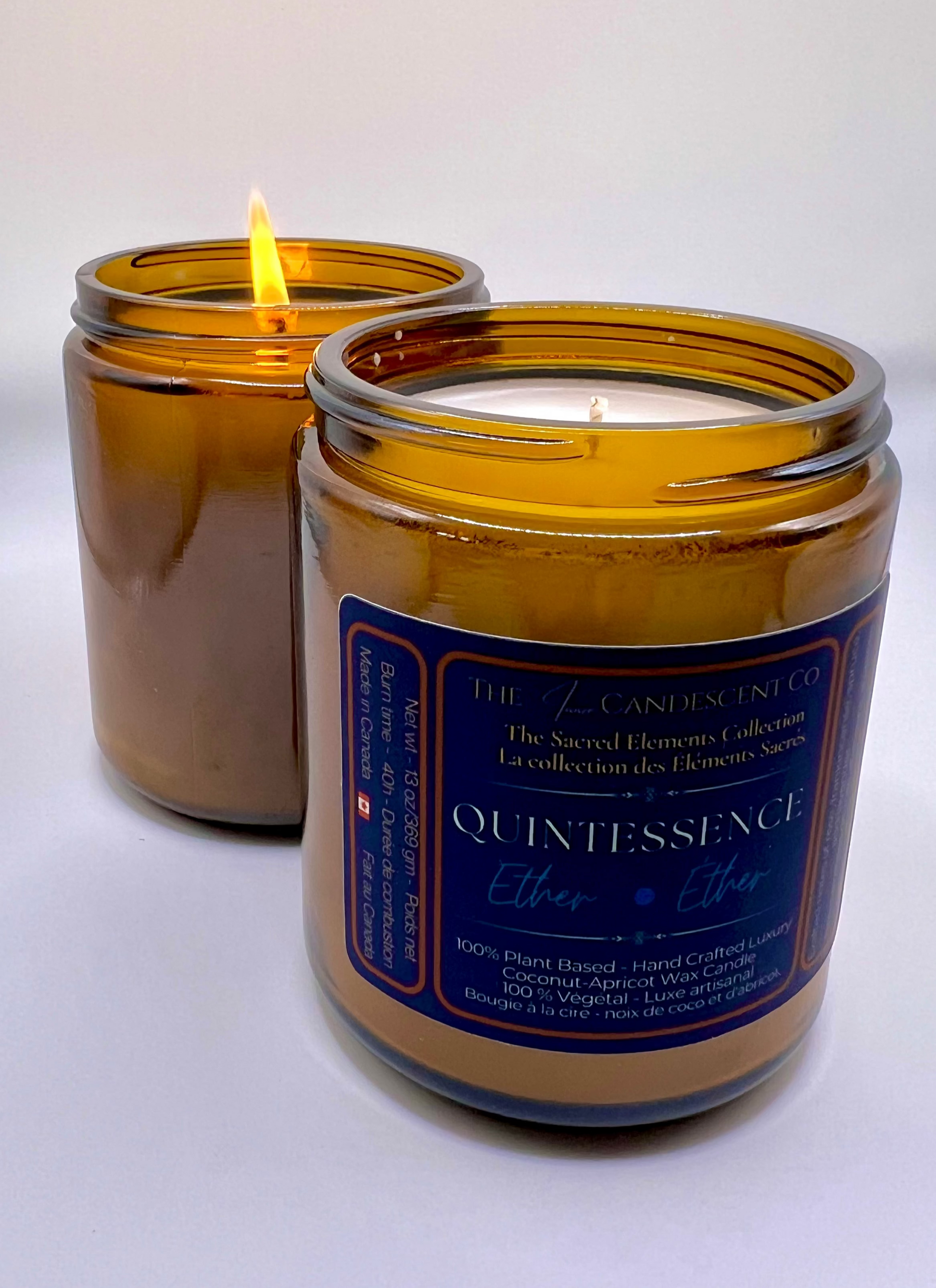 Two amber glass candles with blue labels on a white background