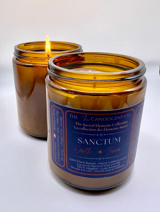 Candle in an amber glass jar with a blue label on a white background