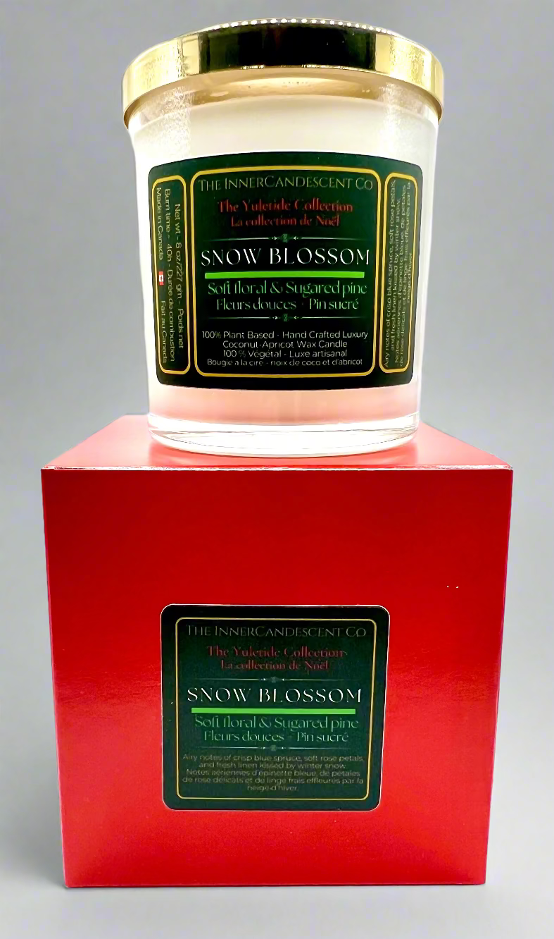Snow Blossom candle in a red box with a green label