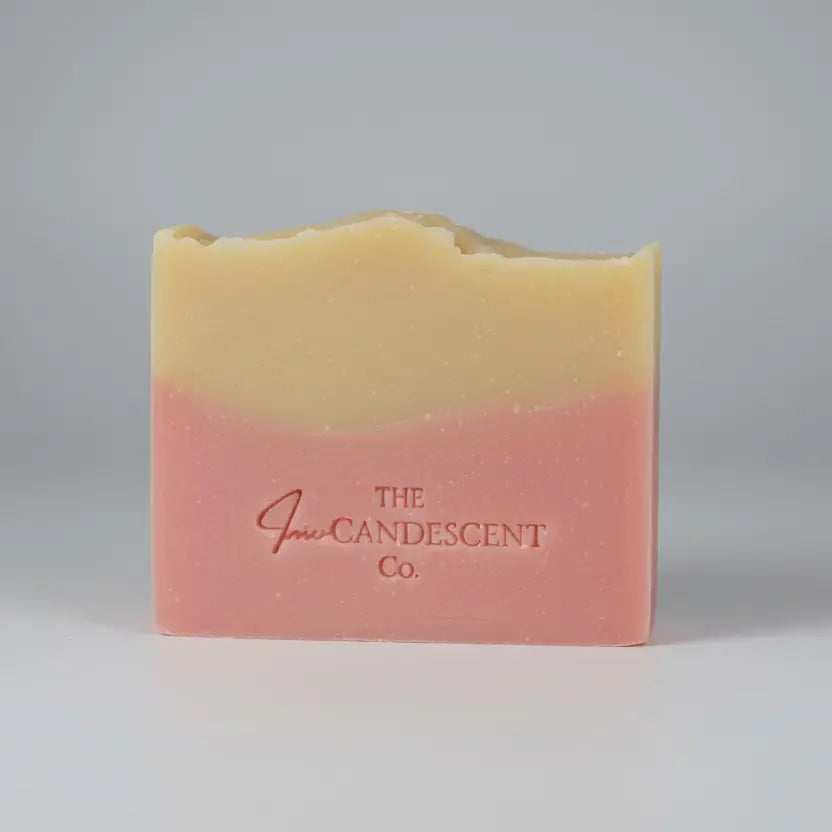 Two-tone soap bar with 'The Candle Company' branding on a textured surface.