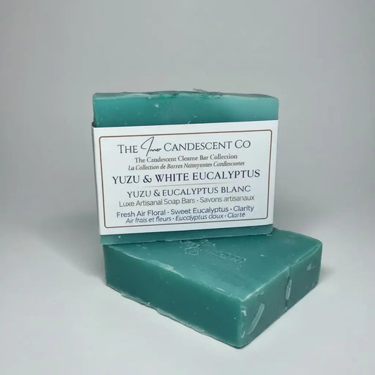 Green soap bar with packaging labeled 'The Candescent Co' on a textured surface.